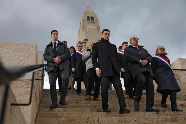 President of French far-right party Rassemblement National (RN) Jordan Bardella (C) and Rassemblement National's MP Florence Goulet (R) visit Verdun's memorial during the 110th anniversary of the start of the Battle of Verdun, in Verdun on February 21, 2026. (Photo by Romeo BOETZLE / AFP)