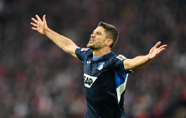 Hoffenheim's Croatian forward #27 Andrej Kramaric celebrates his 1-2 during the German first division Bundesliga football match 1 FC Cologne v TSG 1899 Hoffenheim in Cologne, western Germany, on February 21, 2026. (Photo by INA FASSBENDER / AFP) / DFL REGULATIONS PROHIBIT ANY USE OF PHOTOGRAPHS AS IMAGE SEQUENCES AND/OR QUASI-VIDEO