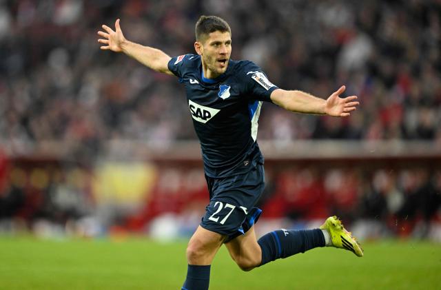 Hoffenheim's Croatian forward #27 Andrej Kramaric celebrates his 1-2 during the German first division Bundesliga football match 1 FC Cologne v TSG 1899 Hoffenheim in Cologne, western Germany, on February 21, 2026. (Photo by INA FASSBENDER / AFP) / DFL REGULATIONS PROHIBIT ANY USE OF PHOTOGRAPHS AS IMAGE SEQUENCES AND/OR QUASI-VIDEO