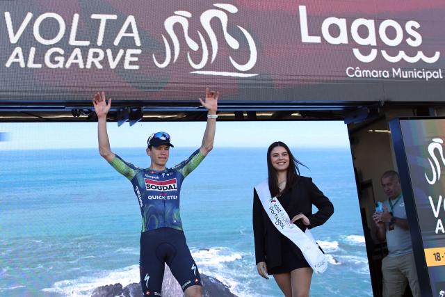 Soudal Quick-Step French cyclist Paul Magnier celebrates on the podium winning the stage four of the Algarve Tour, a 182.10 km race from Albufeira to Lagos, on February 21, 2026. (Photo by João Matos / AFP)