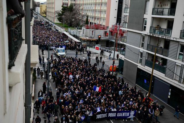 Protesters attend a march in tribute to far-right activist Quentin Deranque, who died after being attacked on the sidelines of a far-right protest against a La France Insoumise (LFI) event at Sciences Po Lyon, in Lyon on February 21, 2026. (Photo by OLIVIER CHASSIGNOLE / AFP)