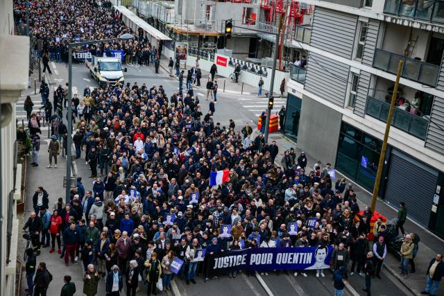Protesters attend a march in tribute to far-right activist Quentin Deranque, who died after being attacked on the sidelines of a far-right protest against a La France Insoumise (LFI) event at Sciences Po Lyon, in Lyon on February 21, 2026. (Photo by OLIVIER CHASSIGNOLE / AFP)