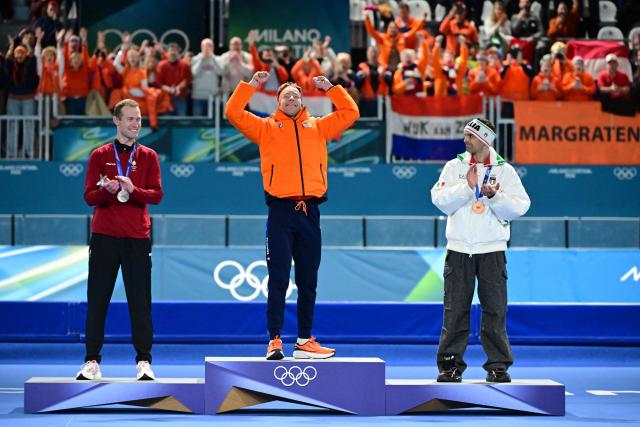 Silver medallist Denmark's Viktor Hald Thorup, gold medallist Netherlands' Jorrit Bergsma and bronze medallist Italy's Andrea Giovannini celebrate on the podium of the speed skating men's mass start final during the Milano Cortina 2026 Winter Olympic Games at Milano Speed Skating Stadium in Milan on February 21, 2026. (Photo by Piero CRUCIATTI / AFP)