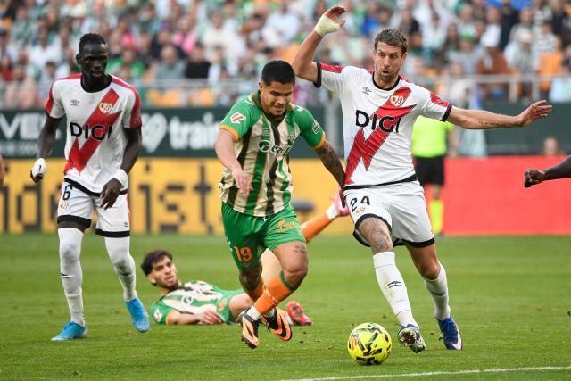Real Betis' Colombian forward #19 Cucho Hernandez and Rayo Vallecano's French defender #24 Florian Lejeune fight for the ball during the Spanish league football match between Real Betis and Rayo Vallecano de Madrid at Benito Villamarin Stadium in Seville on February 21, 2026. (Photo by CRISTINA QUICLER / AFP)