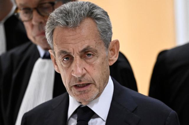 (FILES) Former French president Nicolas Sarkozy speaks to the press after the verdict in his trial for illegal campaign financing from Libya for his successful 2007 presidential bid, at the Tribunal de Paris courthouse in Paris, on September 25, 2025. Paris courthouse will exemine on February 23, 2026 Nicolas Sarkozy's request to combine the sentences handed down in the Bygmalion and Bismuth cases. (Photo by JULIEN DE ROSA / AFP)