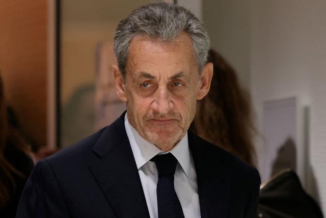 (FILES) Former French president Nicolas Sarkozy leaves after the verdict in his trial for illegal campaign financing from Libya for his successful 2007 presidential bid, at the Tribunal de Paris courthouse in Paris, on September 25, 2025. Paris courthouse will exemine on February 23, 2026 Nicolas Sarkozy's request to combine the sentences handed down in the Bygmalion and Bismuth cases. (Photo by Alain JOCARD / AFP)