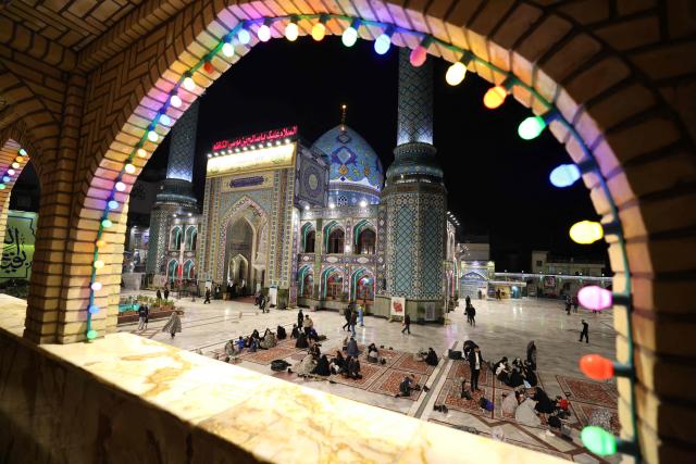 Iranian families sits together to break the dawn to dusk Ramadan fast during Iftar, in the grounds of the Imamzadeh Saleh mosque in Tehran on February 21, 2026. Muslims throughout the world are marking the month of Ramadan, the holiest month in the Islamic calendar, during which devotees fast from dawn until dusk. (Photo by ATTA KENARE / AFP)
