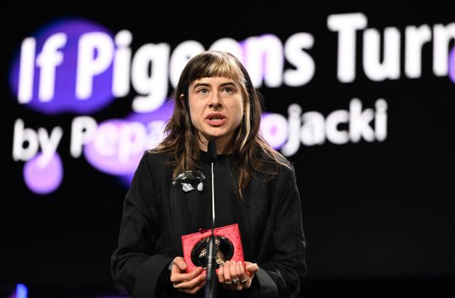 Filmmaker Pepa Lubojacki accepts her Berlinale Documentary Award for her film "If Pigeons Turned to Gold" during the Award Ceremony of the 76th Berlinale, Europe's first major film festival of the year, in Berlin on February 21, 2026. The 76th Berlin Film Festival draws to a close after 10 days, with 22 films in competition. (Photo by RALF HIRSCHBERGER / AFP)