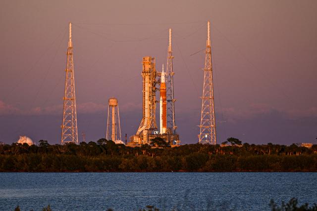 (FILES) The Space Launch System (SLS) rocket and the Orion spacecraft, integrated for the Artemis II mission, are seen at Launch Pad 39B at the Kennedy Space Center in Cape Canaveral, Florida, on February 1, 2026 ahead of the first crewed mission to the Moon in more than 50 years. NASA chief Jared Isaacman on February 21, 2026, ruled out a March launch for Artemis 2, the first crewed flyby mission to the Moon in more than 50 years, citing technical issues. Workers detected a problem with helium flow to the massive SLS rocket that will "take the March launch window out of consideration," Issacman said in a post on X. (Photo by Miguel J. Rodriguez Carrillo / AFP)