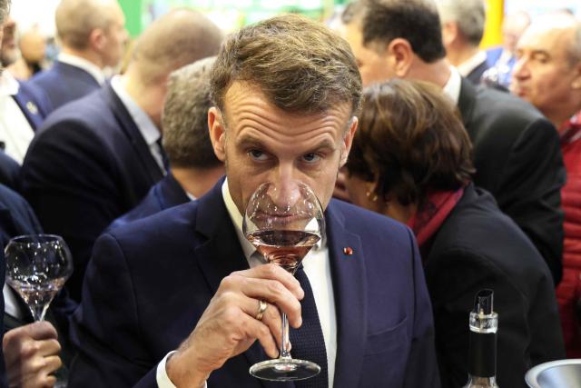 France's President Emmanuel Macron tastes wine during the opening of the International Agricultural Show (Salon de l'Agriculture) at Paris Expo Porte de Versailles in Paris on February 21, 2026. (Photo by Ludovic MARIN / POOL / AFP)