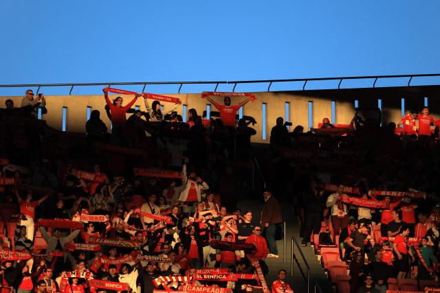 Fans of Benfica cheer for their team during the Portuguese League football match between SL Benfica and AVS Futebol SAD at Estadio da Luz in Lisbon on February 21, 2026. (Photo by PATRICIA DE MELO MOREIRA / AFP)