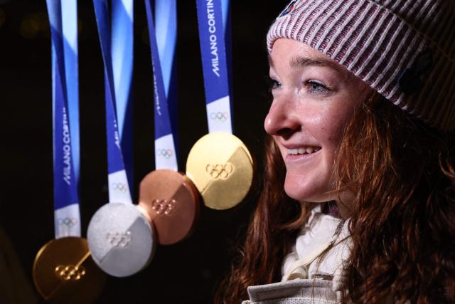 France's Lou Jeanmonnot poses with her medals during the Milano Cortina 2026 Winter Olympic Games in Anterselva (Val Pusteria) on February 21, 2026. (Photo by FRANCK FIFE / AFP)