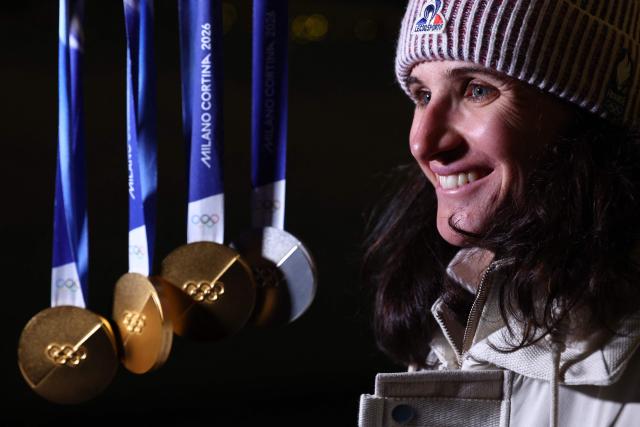 France's Julia Simon poses with her medals during the Milano Cortina 2026 Winter Olympic Games in Anterselva (Val Pusteria) on February 21, 2026. (Photo by FRANCK FIFE / AFP)
