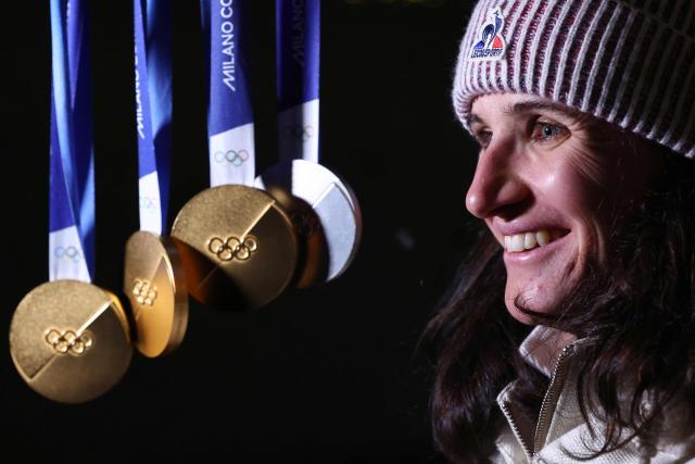 France's Julia Simon poses with her medals during the Milano Cortina 2026 Winter Olympic Games in Anterselva (Val Pusteria) on February 21, 2026. (Photo by FRANCK FIFE / AFP)
