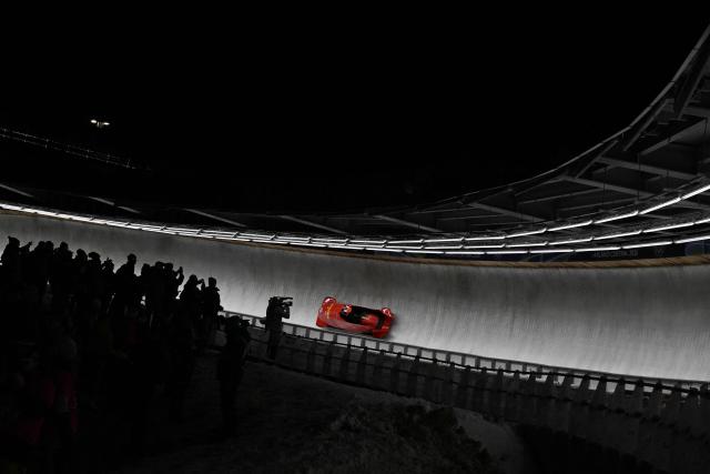 China's Huai Mingming and China's Wang Xuan compete in  the bobsleigh women's 2-woman heat 3 at Cortina Sliding Centre during the Milano Cortina 2026 Winter Olympic Games in Cortina d'Ampezzo on February 21, 2026. (Photo by Tiziana FABI / AFP)