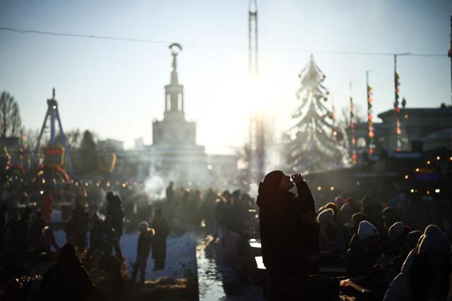 A person drinks at a Masnytsya (Shrovetide) celebration, a traditional Eastern Slavic religious and folk holiday that marks the end of winter and the beginning of spring, at the Expocentre of Ukraine in Kyiv on February 21, 2024, amid the Russian invasion of Ukraine. (Photo by HENRY NICHOLLS / AFP)