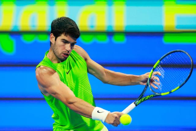 Spain's Carlos Alcaraz hits a return against France's Arthur Fils during their men’s singles final match at the Qatar Open tennis tournament in Doha on February 21, 2026. (Photo by Karim JAAFAR / AFP)