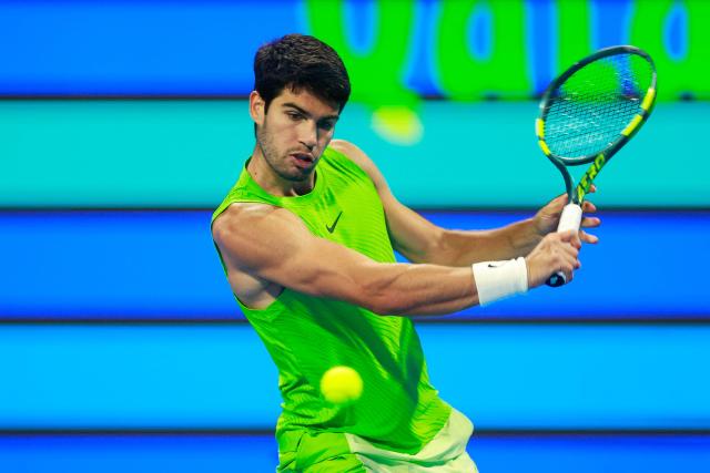 Spain's Carlos Alcaraz hits a return against France's Arthur Fils during their men’s singles final match at the Qatar Open tennis tournament in Doha on February 21, 2026. (Photo by Karim JAAFAR / AFP)