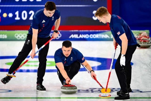 Great Britain's Grant Hardie, Britain's Hammy McMillan delivering a stone and Britain's Bobby Lammie during the curling men's gold medal game between Great Britain and Canada during the Milano Cortina 2026 Winter Olympic Games at the Cortina Curling Olympic Stadium in Cortina d’Ampezzo on February 21, 2026. (Photo by Marco BERTORELLO / AFP)