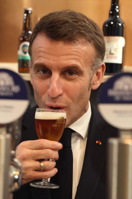 France's President Emmanuel Macron tastes a beer at the Brewers of France's booth during the opening of the International Agricultural Show (Salon de l'Agriculture) at Paris Expo Porte de Versailles in Paris on February 21, 2026. (Photo by Ludovic MARIN / POOL / AFP)