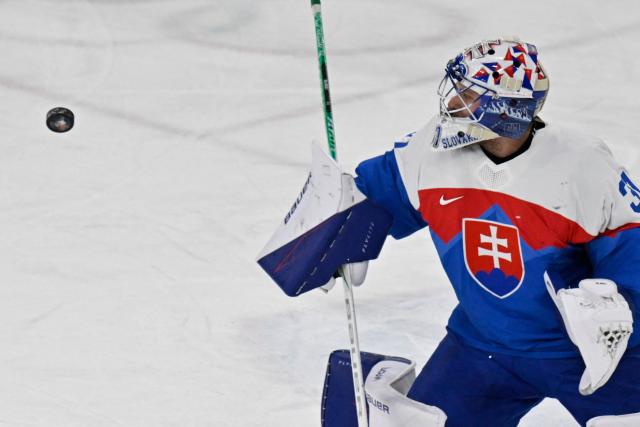 Slovakia's #31 Samuel Hlavaj eyes the puck during the men's bronze medal ice hockey match between Slovakia and Finland at the Milano Santagiulia Ice Hockey Arena during the Milano Cortina 2026 Winter Olympic Games in Milan, on February 21, 2026. (Photo by Alexander NEMENOV / AFP)