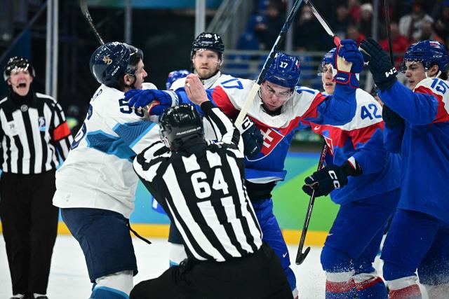 Finland's #56 Erik Haula, Slovakia's #17 Simon Nemec Slovakia's #42 Martin Fehervary and Slovakia's #15 Dalibor Dvorsky scuffle during the men's bronze medal ice hockey match between Slovakia and Finland at the Milano Santagiulia Ice Hockey Arena during the Milano Cortina 2026 Winter Olympic Games in Milan, on February 21, 2026. (Photo by JULIEN DE ROSA / AFP)