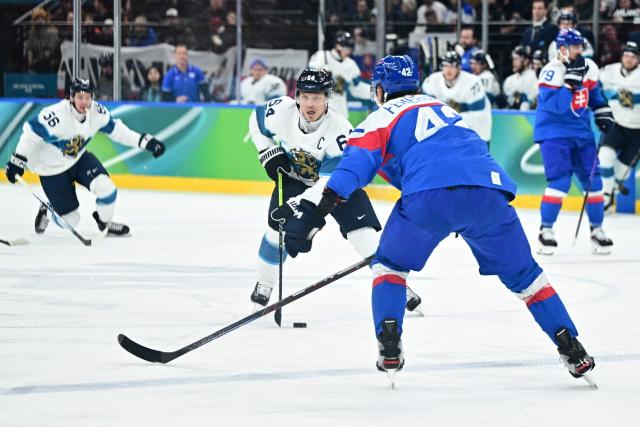 Finland's #64 Mikael Granlund fights for the puck with Slovakia's #42 Martin Fehervary during the men's bronze medal ice hockey match between Slovakia and Finland at the Milano Santagiulia Ice Hockey Arena during the Milano Cortina 2026 Winter Olympic Games in Milan, on February 21, 2026. (Photo by JULIEN DE ROSA / AFP)
