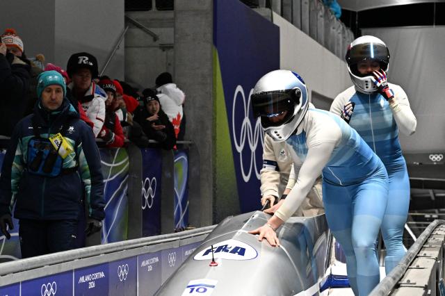 France's Margot Boch and France's Carla Senechal react after competing in the bobsleigh women's 2-woman heat 4 at Cortina Sliding Centre during the Milano Cortina 2026 Winter Olympic Games in Cortina d'Ampezzo on February 21, 2026. (Photo by Tiziana FABI / AFP)