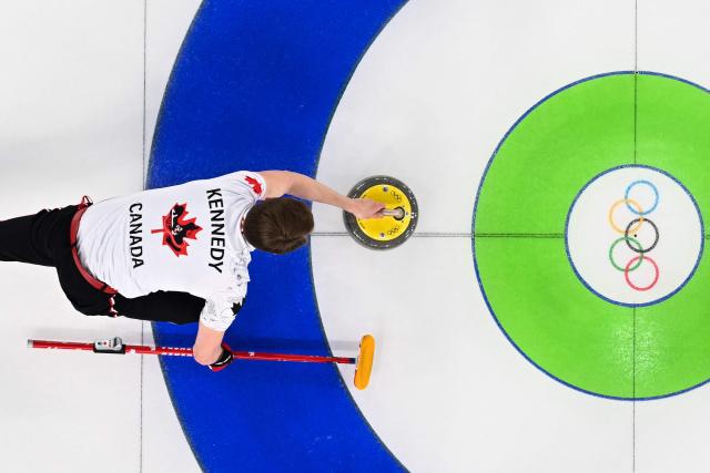Canada's Marc Kennedy delivers a stone during the curling men's gold medal game between Great Britain and Canada during the Milano Cortina 2026 Winter Olympic Games at the Cortina Curling Olympic Stadium in Cortina d’Ampezzo on February 21, 2026. (Photo by Franзois-Xavier MARIT / AFP)