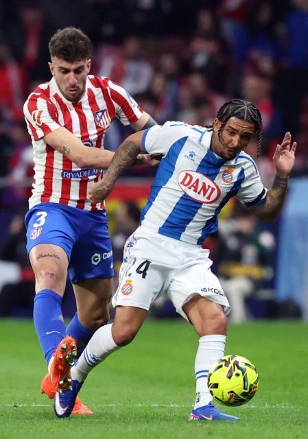 Atletico Madrid's Italian defender #03 Matteo Ruggeri and Espanyol's English forward #24 Tyrhys Dolan fight for the ball during the Spanish league football match between Club Atletico de Madrid and RCD Espanyol at Metropolitano Stadium in Madrid on February 21, 2026. (Photo by Pierre-Philippe MARCOU / AFP)