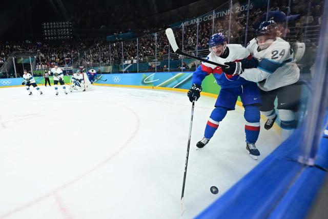 Slovakia's #08 Oliver Okuliar (L) fights for the puck with Finland's #24 Roope Hintz during the men's bronze medal ice hockey match between Slovakia and Finland at the Milano Santagiulia Ice Hockey Arena during the Milano Cortina 2026 Winter Olympic Games in Milan, on February 21, 2026. (Photo by JULIEN DE ROSA / AFP)