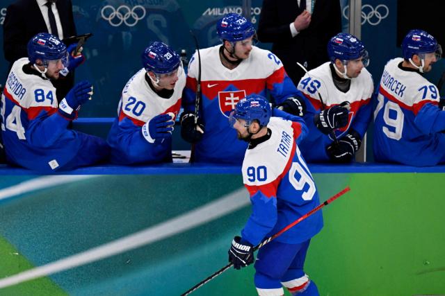 Slovakia's #90 Tomas Tatar (bototm C) celebrates with teammates after scoring his team's first goal during the men's bronze medal ice hockey match between Slovakia and Finland at the Milano Santagiulia Ice Hockey Arena during the Milano Cortina 2026 Winter Olympic Games in Milan, on February 21, 2026. (Photo by Alexander NEMENOV / AFP)