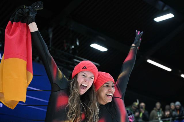 Germany's Laura Nolte and Germany's Deborah Levi celebrate after winning the bobsleigh women's 2-woman event at Cortina Sliding Centre during the Milano Cortina 2026 Winter Olympic Games in Cortina d'Ampezzo on February 21, 2026. (Photo by Tiziana FABI / AFP)