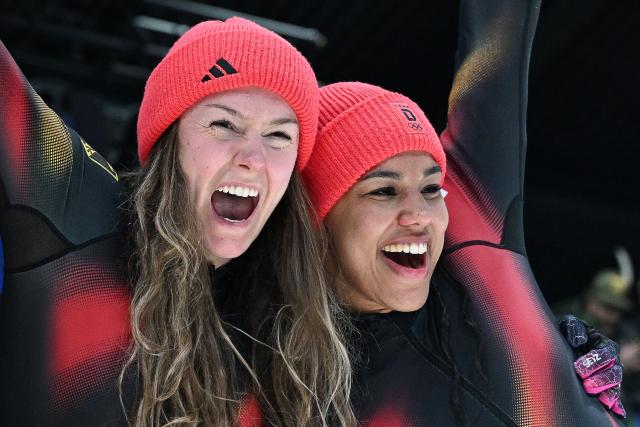 Germany's Laura Nolte and Germany's Deborah Levi celebrate after winning the bobsleigh women's 2-woman event at Cortina Sliding Centre during the Milano Cortina 2026 Winter Olympic Games in Cortina d'Ampezzo on February 21, 2026. (Photo by Tiziana FABI / AFP)