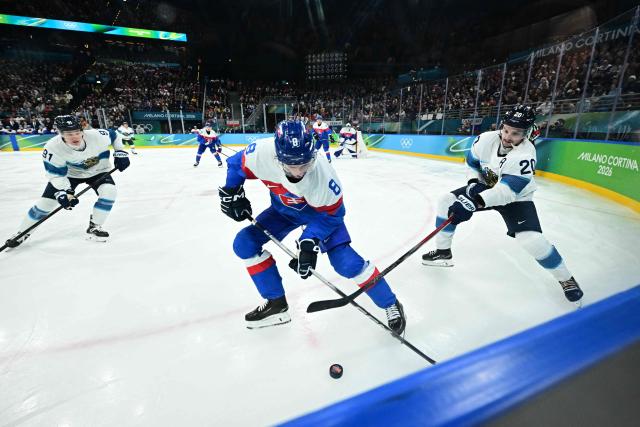 Slovakia's #08 Oliver Okuliar and Finland's #20 Sebastian Aho fight for the puck during the men's bronze medal ice hockey match between Slovakia and Finland at the Milano Santagiulia Ice Hockey Arena during the Milano Cortina 2026 Winter Olympic Games in Milan, on February 21, 2026. (Photo by JULIEN DE ROSA / AFP)