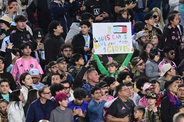 A local fan holds a sign with a message for LAFC' French goalkeeper #01 Hugo Lloris before the start of the Major League Soccer opening match between Los Angeles Football Club and Inter Miami CF at the LA Memorial Coliseum in Los Angeles, on February 21, 2026. (Photo by Frederic J. Brown / AFP)