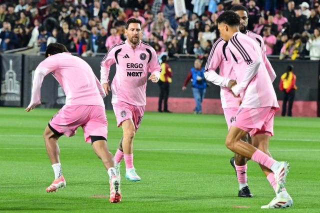 Inter Miami's Argentine forward #10 Lionel Messi (2-L) warms up with teammates before the start of the Major League Soccer opening match between Los Angeles Football Club and Inter Miami CF at the LA Memorial Coliseum in Los Angeles, on February 21, 2026. (Photo by Frederic J. Brown / AFP)