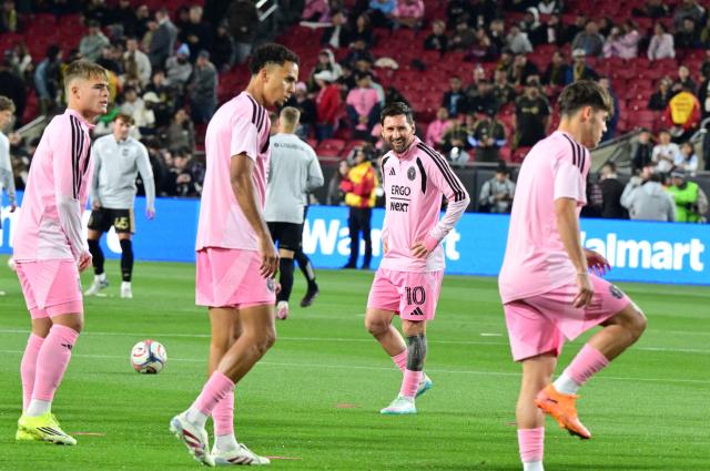Inter Miami's Argentine forward #10 Lionel Messi (2-R) warms up with teammates before the start of the Major League Soccer opening match between Los Angeles Football Club and Inter Miami CF at the LA Memorial Coliseum in Los Angeles, on February 21, 2026. (Photo by Frederic J. Brown / AFP)