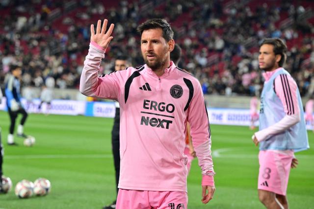 Inter Miami's Argentine forward #10 Lionel Messi waves while warming up before the start of the Major League Soccer opening match between Los Angeles Football Club and Inter Miami CF at the LA Memorial Coliseum in Los Angeles, on February 21, 2026. (Photo by Frederic J. Brown / AFP)