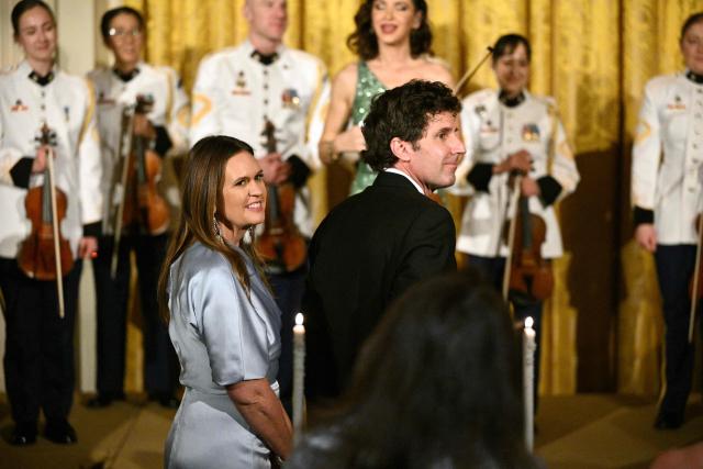 Arkansas Governor Sarah Huckabee Sanders (L) and her husband Bryan Sanders attend a dinner with state governors hosted by President Donald Trump in the East Room of the White House in Washington, DC, on February 21, 2026. (Photo by Mandel NGAN / AFP)