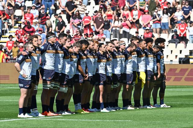 Brumbies players observe a minute's silence to remember victims of the 2011 Christchurch earthquake on February 22, 2011, during round two of the Super Rugby Pacific match between the Crusaders and Brumbies at Apollo Projects Stadium in Christchurch on February 22, 2026. (Photo by Sanka VIDANAGAMA / AFP)