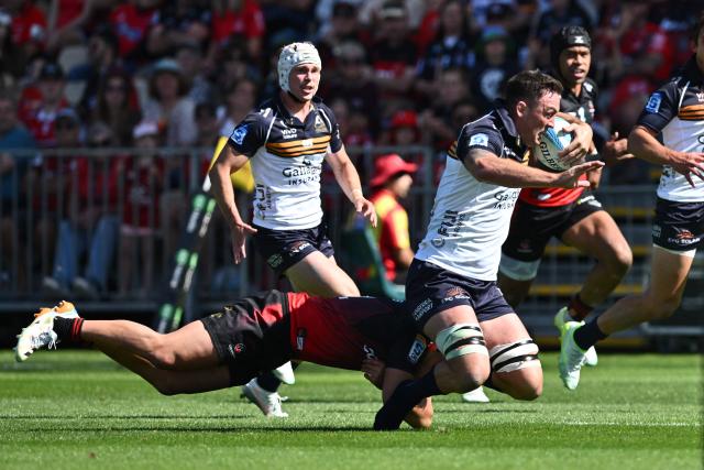 Brumbies' Cadeyrn Neville (R) is tackled by Crusaders' David Havili during round two of the Super Rugby Pacific match between the Crusaders and Brumbies at Apollo Projects Stadium in Christchurch on February 22, 2026. (Photo by Sanka VIDANAGAMA / AFP)