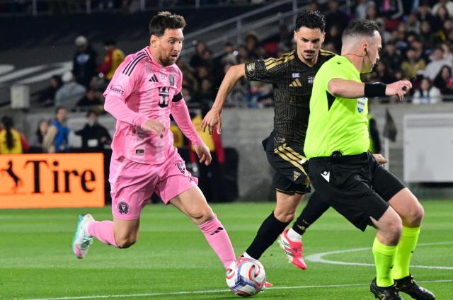 Inter Miami's Argentine forward #10 Lionel Messi (L) controls the ball against LAFC's Canadian midfielder #46 Stephen Eustaquio during the Major League Soccer opening match between Los Angeles Football Club and Inter Miami CF at the LA Memorial Coliseum in Los Angeles, on February 21, 2026. (Photo by Frederic J. Brown / AFP)