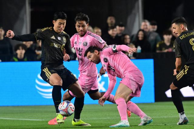 LAFC's South Korean forward #07 Son Heung-min (L) fights for the ball with Inter Miami's Argentine forward #10 Lionel Messi (2R) as Inter Miami's Venezuelan midfielder #08 Telasco Segovia looks on during the Major League Soccer opening match between Los Angeles Football Club and Inter Miami CF at the LA Memorial Coliseum in Los Angeles, on February 21, 2026. (Photo by Frederic J. Brown / AFP)