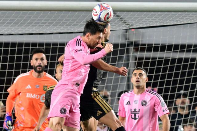 Inter Miami's Argentine forward #10 Lionel Messi (L) and LAFC's Canadian midfielder #46 Stephen Eustaquio go up for a header during the Major League Soccer opening match between Los Angeles Football Club and Inter Miami CF at the LA Memorial Coliseum in Los Angeles, on February 21, 2026. (Photo by Frederic J. Brown / AFP)