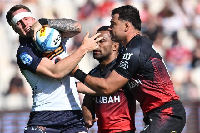 Brumbies' Corey Toole (L) is tackled by Crusaders' David Havili during round two of the Super Rugby Pacific match between the Crusaders and Brumbies at Apollo Projects Stadium in Christchurch on February 22, 2026. (Photo by Sanka VIDANAGAMA / AFP)
