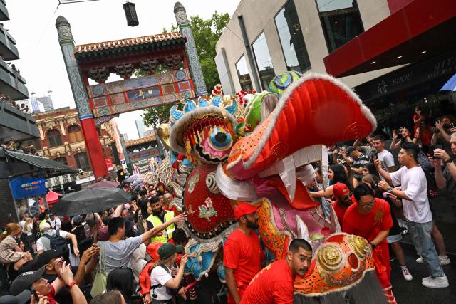 A giant dragon snakes it's way though Chinatown during celebrations marking the Lunar New Year of the Horse in Melbourne on February 22, 2026. (Photo by William WEST / AFP)