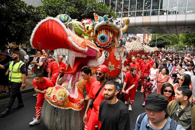 A giant dragon snakes it's way though Chinatown during celebrations marking the Lunar New Year of the Horse in Melbourne on February 22, 2026. (Photo by William WEST / AFP)