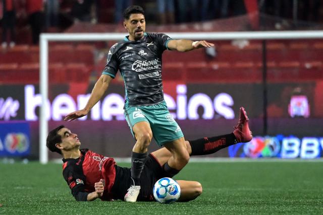 Tijuana's Spanish defender #04 Unai Bilbao (bottom) and Mazatlan's forward #15 Brian Rubio fight for the ball during the Liga MX Clausura football match between Tijuana and Mazatlan at the Caliente Stadium in Tijuana, Mexico on February 21, 2026. (Photo by Guillermo Arias / AFP)