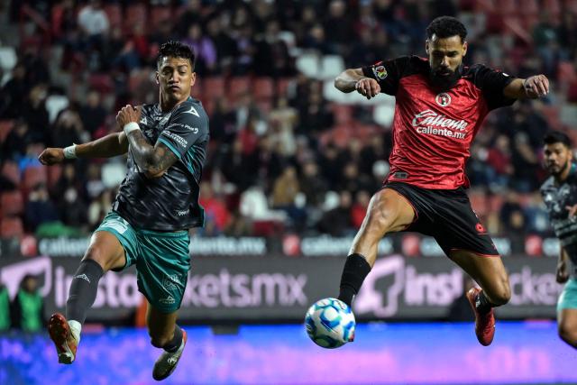 Tijuana's Spanish forward #09 Mourad El Ghezouani (R) and Mazatlan's Argentine defender #19 Lucas Merolla fight for the ball during the Liga MX Clausura football match between Tijuana and Mazatlan at the Caliente Stadium in Tijuana, Mexico on February 21, 2026. (Photo by Guillermo Arias / AFP)